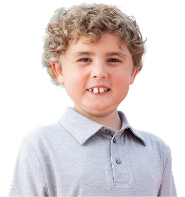 Tripp, a young boy living with Duchenne, smiling at the camera