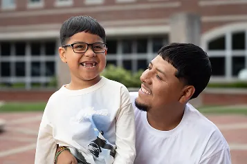 Smiling young boy with his father