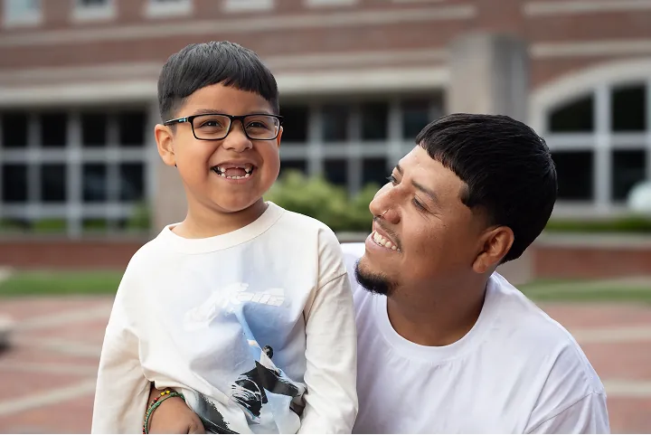 Smiling young boy with his father