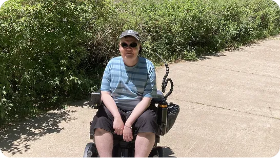 Colin sitting outside on a sunny day