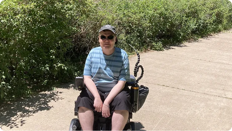Colin sitting outside on a sunny day