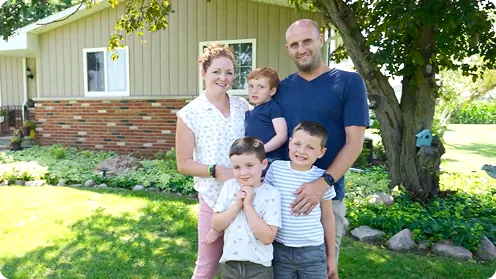 Emmett and his family outside their home
