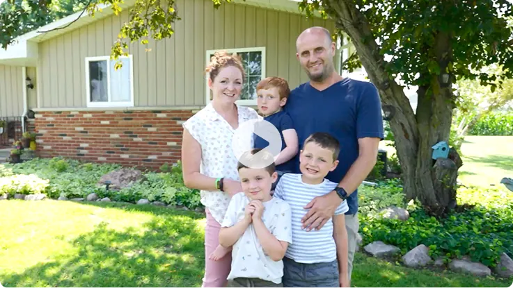 Video thumbnail: Emmett and his family standing together outdoors. Watch Emmett's story.