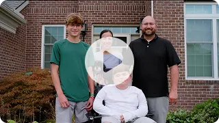 Video thumbnail: Nathan and his family standing together outside their home. Watch Nathan's story.