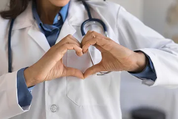 Doctor making a heart symbol with hands in front of chest