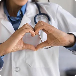 Doctor making a heart symbol with hands in front of chest