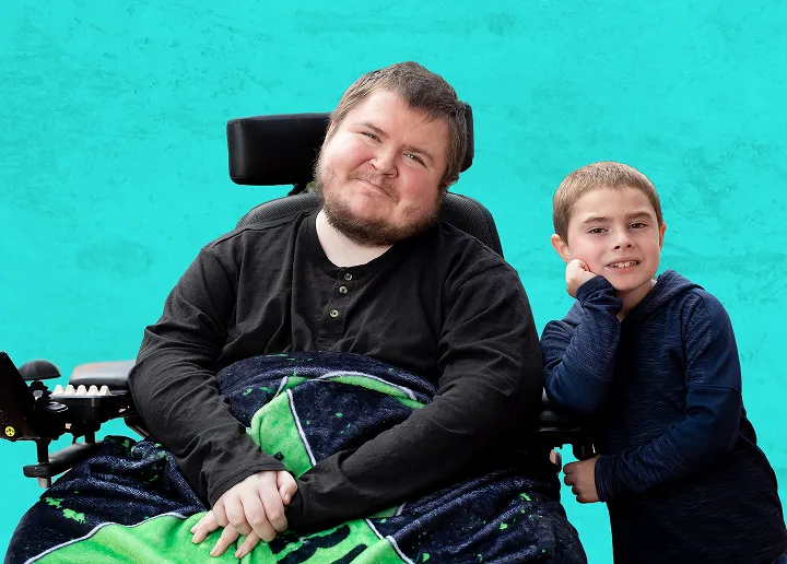 Triston and Nicholas, both living with Duchenne, smiling together